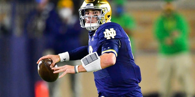 Notre Dame quarterback Ian Book looks for a receiver during the first quarter against Clemson in an NCAA college football game Saturday, Nov. 7, 2020, in South Bend, Ind. (Matt Cashore/Pool Photo via AP)