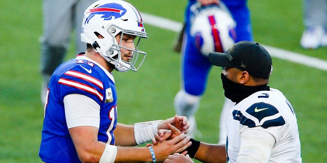 Buffalo Bills' Josh Allen, left, shakes hands with Seattle Seahawks' Russell Wilson after an NFL football game Sunday, Nov. 8, 2020, in Orchard Park, N.Y. (AP Photo/John Munson)