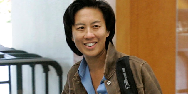 FILE - In this Nov. 5, 2007 file photo, Los Angeles Dodgers assistant general manager Kim Ng walks through the hotel lobby during the first day of Major League Baseball annual general managers meetings in Orlando, Fla. Ng has become the highest-ranking woman in baseball operations in the major leagues. She was hired Friday, Nov. 13, 2020, as general manager of the Miami Marlins. (AP Photo/John Raoux, file)