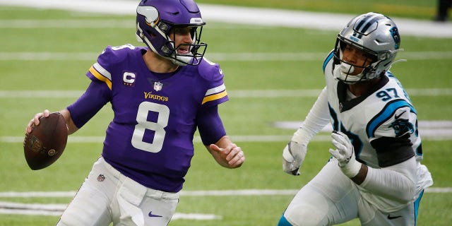 Minnesota Vikings quarterback Kirk Cousins (8) runs from Carolina Panthers defensive end Yetur Gross-Matos (97) during the first half of an NFL football game, Sunday, Nov. 29, 2020, in Minneapolis. (AP Photo/Bruce Kluckhohn)