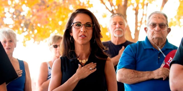 Lauren Boebert (C), the Republican candidate for the US House of Representatives seat in Colorado's 3rd Congressional District, recites the Pledge of Allegiance before addressing supporters at a campaign rally in Delta, Colorado on October 10, 2020. (Photo by JASON CONNOLLY/AFP via Getty Images)