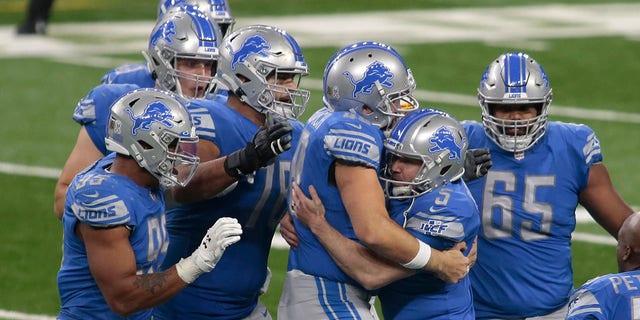 Detroit Lions teammates surround kicker Matt Prater (5) after his winning field goal in the closing seconds during the second half of an NFL football game against the Washington Football Team, Sunday, Nov. 15, 2020, in Detroit. (AP Photo/Tony Ding)