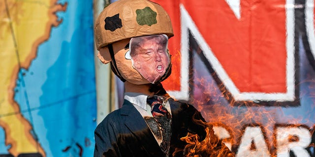 A Trump piñata is burnt during a protest against his administration's immigration policies on the U.S. border in Tijuana.