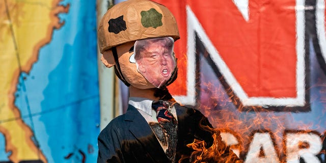 A Trump piñata is burnt during a protest against his administration's immigration policies on the U.S. border in Tijuana.