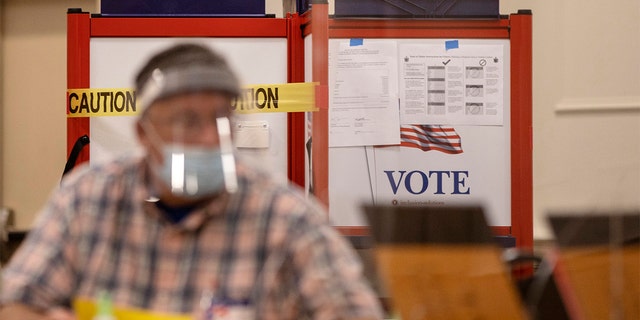 A voting booth with sides blocked off with caution tape to ensure social distancing at the Italian Heritage Center on Tuesday, July 14, 2020. (Brianna Soukup/Portland Press Herald via Getty Images)