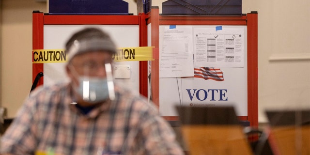 A voting booth with sides blocked off with caution tape to ensure social distancing at the Italian Heritage Center in Portland, Maine. (Staff photo by Brianna Soukup/Portland Press Herald via Getty Images)