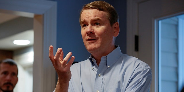 Sen. Michael Bennet speaks to voters at a house party in Manchester, New Hampshire, Dec. 8, 2019.