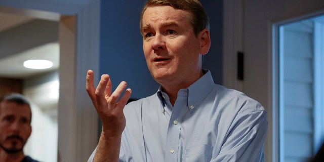 Sen. Michael Bennet speaks to voters at a house party in Manchester, New Hampshire, Dec. 8, 2019.