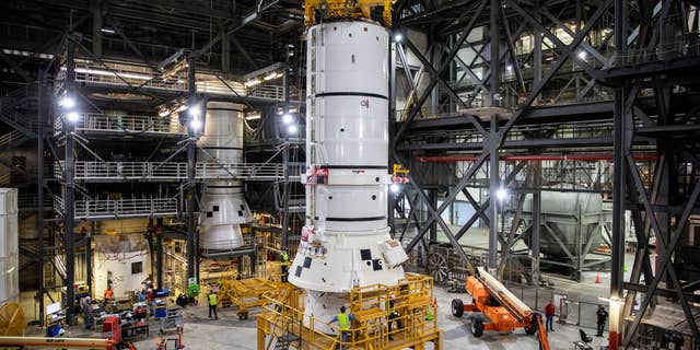 The rear parts of the Space Launch System solid rocket launchers for the Artemis I mission are preparing to move from High Bay 4 inside NASA's Vehicle Assembly Building (VAB) at Kennedy Space Center in Florida to the mobile launcher inside the high bay 3 to stack.