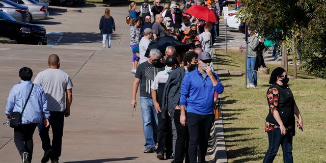 The line for early voting at a polling place in Oklahoma County wraps around the Edmond Church of Christ and more, Oct. 30, 2020, in Edmond, Oklahoma.