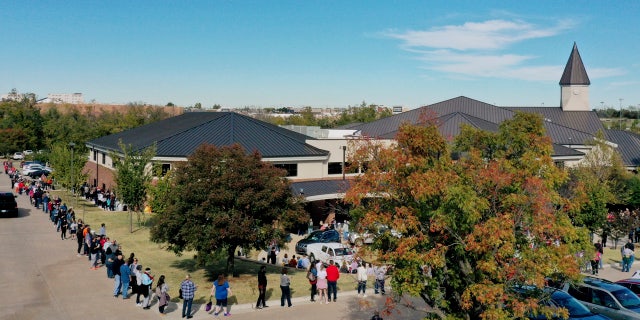 In this Friday, Oct. 30, 2020 file photo, the line for early voting at a polling place in Oklahoma County wraps around Edmond Church of Christ in Edmond, Okla.
