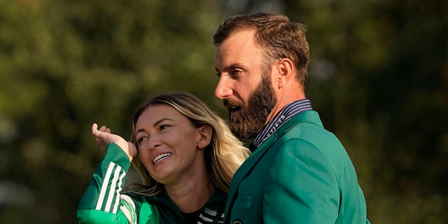Masters golf champion Dustin Johnson is hugged by Paulina Gretzky after his victory Sunday, Nov. 15, 2020, in Augusta, Ga. 