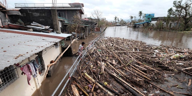 On Thursday, November 12, 2020, floods inundated a village in Legazpi, Philippines. A man looked at the garbage washed away by Typhoon Vamco.