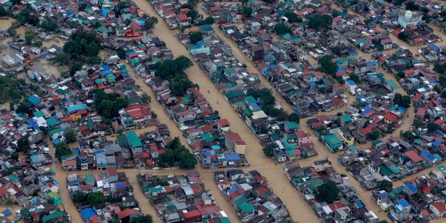 In this photo provided by the Department of Photographers of the President of Malacañang, the flood purchased by Typhoon Vamko submerged Metro Manila, Philippines, on Thursday, November 12, 2020.