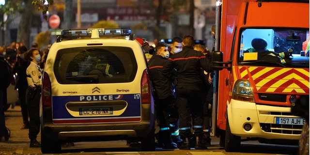 Police officers and rescue workers block the access to the scene after a Greek Orthodox priest was shot Saturday Oct.31, 2020 while he was closing his church in the city of Lyon, central France. (Associated Press)