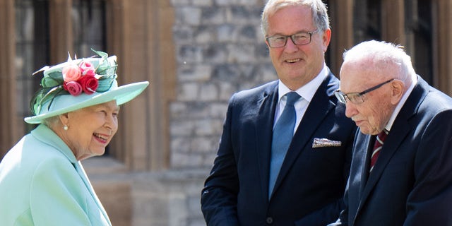Queen Elizabeth II spoke to Captain Sir Thomas Moore and his family at Windsor Castle on July 17, 2020. She was not publicly photographed with a mask. (Photo by Pool / Samir Hussein / WireImage)