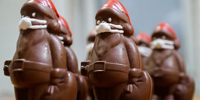 Chocolate Santas are seasonal Santa-shaped candies that gain popularity around Christmastime. Here's a row of chocolate Santas wearing protective face masks in the workshop of the Hungarian confectioner Laszlo Rimoczi, in Lajosmizse, Hungary, during the pandemic in 2020. 