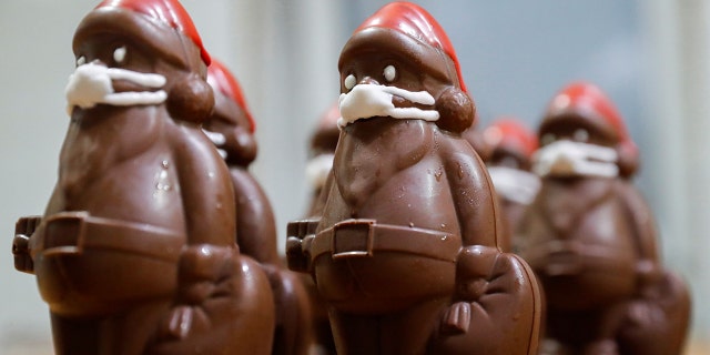 Chocolate Santas are seasonal Santa-shaped candies that gain popularity around Christmastime. Here's a row of chocolate Santas wearing protective face masks in the workshop of the Hungarian confectioner Laszlo Rimoczi, in Lajosmizse, Hungary, during the pandemic in 2020.