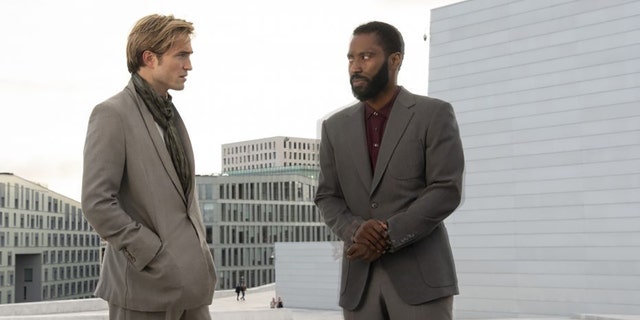 This image released by Warner Bros. Entertainment shows Robert Pattinson, left, and John David Washington in a scene from 'Tenet.' 