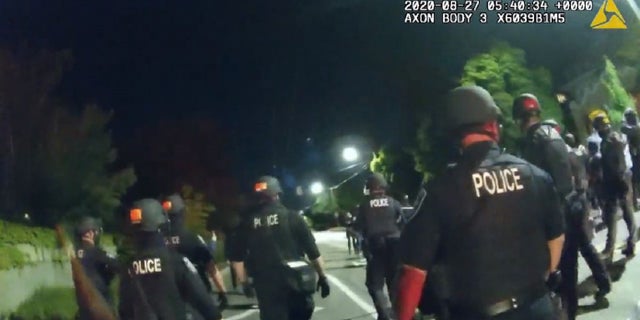 Seattle police officers attempt to disperse a crowd during an August demonstration.