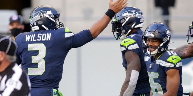 Seattle Seahawks quarterback Russell Wilson (3) celebrates with wide receiver DK Metcalf, center, after Wilson passed to Metcalf for a touchdown against the San Francisco 49ers during the first half of an NFL football game, Sunday, Nov. 1, 2020, in Seattle. (AP Photo/Scott Eklund)