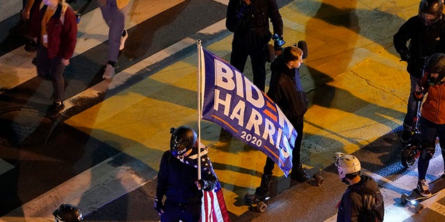 People gather in Black Lives Matter Plaza near the White House in Washington, Tuesday, Nov. 3, 2020, on Election Day. (AP Photo/Susan Walsh)