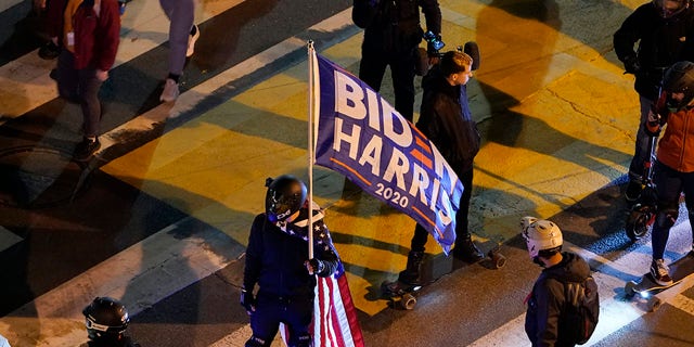People gather in Black Lives Matter Plaza near the White House in Washington, Tuesday, Nov. 3, 2020, on Election Day. (AP Photo/Susan Walsh)