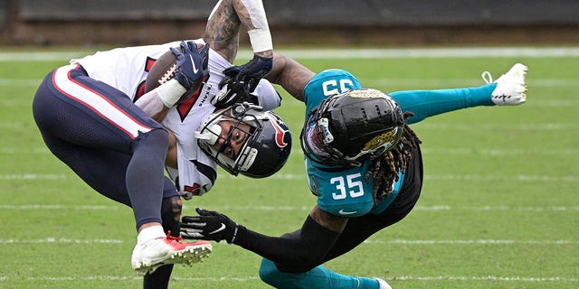 Houston Texans wide receiver Will Fuller V, left, is tackled by Jacksonville Jaguars cornerback Luq Barcoo (36) after a reception during the second half of an NFL football game, Sunday, Nov. 8, 2020, in Jacksonville, Fla. (AP Photo/Phelan M. Ebenhack)