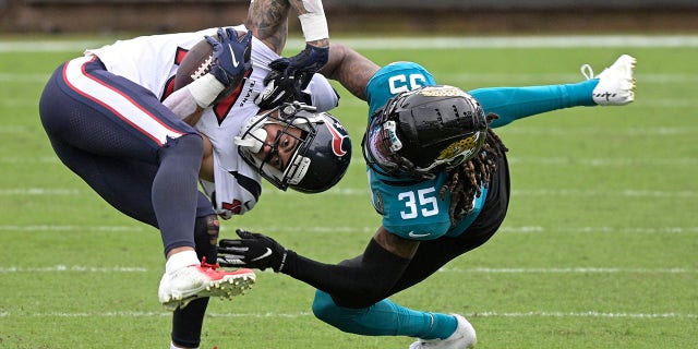 Houston Texans wide receiver Will Fuller V, left, is tackled by Jacksonville Jaguars cornerback Luq Barcoo (36) after a reception during the second half of an NFL football game, Sunday, Nov. 8, 2020, in Jacksonville, Fla. (AP Photo/Phelan M. Ebenhack)
