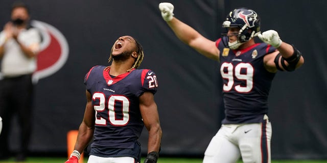 Houston Texans strong safety Justin Reid (20) and defensive end J.J. Watt (99) celebrate their win over the New England Patriots in an NFL football game, Sunday, Nov. 22, 2020, in Houston. (AP Photo/David J. Phillip)