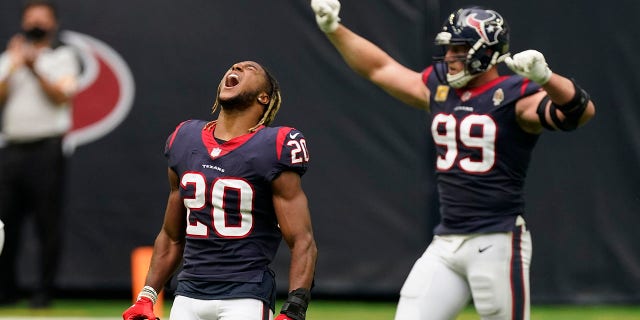 Houston Texans strong safety Justin Reid (20) and defensive end J.J. Watt (99) celebrate their win over the New England Patriots in an NFL football game, Sunday, Nov. 22, 2020, in Houston. (AP Photo/David J. Phillip)