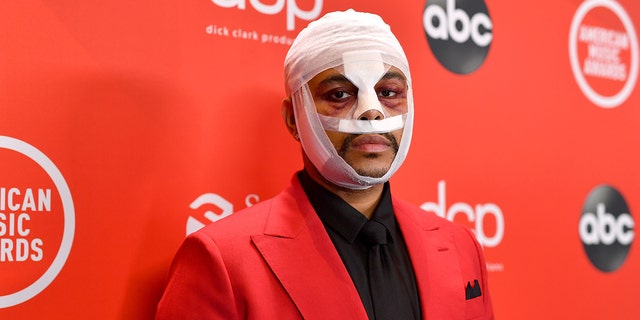 The Weeknd appears on the 2020 AMAs with a bloodied and bandaged face.