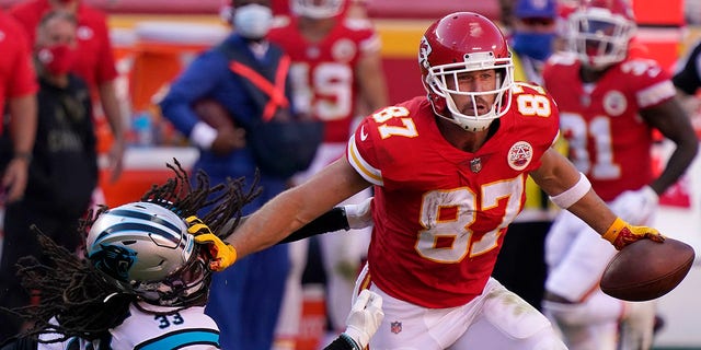 Kansas City Chiefs tight end Travis Kelce (87) runs against Carolina Panthers free safety Tre Boston (33) during the second half of an NFL football game in Kansas City, Mo., Sunday, Nov. 8, 2020. (AP Photo/Jeff Roberson)