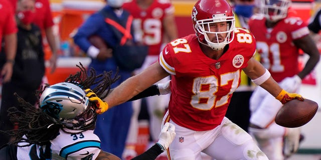 Kansas City Chiefs tight end Travis Kelce (87) runs against Carolina Panthers free safety Tre Boston (33) during the second half of an NFL football game in Kansas City, Mo., Sunday, Nov. 8, 2020. (AP Photo/Jeff Roberson)