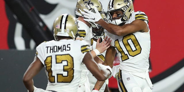 New Orleans Saints wide receiver Tre'Quan Smith (10) celebrates with teammates, including wide receiver wide receiver Michael Thomas (13) after scoring against the Tampa Bay Buccaneers during the first half of an NFL football game Sunday, Nov. 8, 2020, in Tampa, Fla. (AP Photo/Mark LoMoglio)