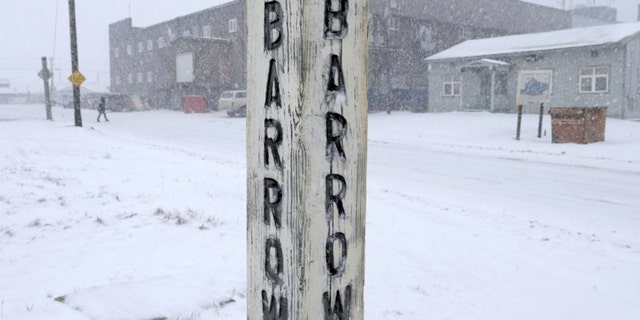 In this Oct. 10, 2014, file di foto, snow falls around a sign in Barrow, Alaska. Residents in Barrow, the nation's northernmost community, have voted to change the name of their city back to its traditional Inupiaq name of Utqiagvik.