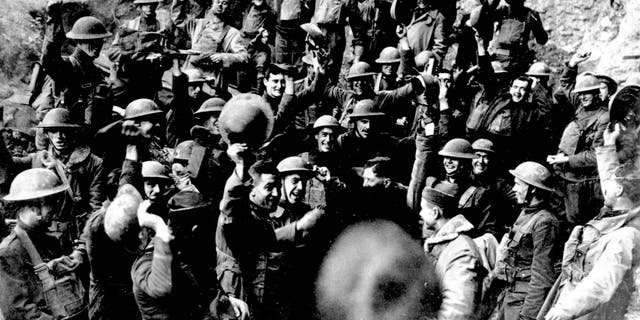 American troops cheer after hearing the news that the Armistice had been signed, ending World War I in Nov. 1918. They were located on the front northeast of St. Mihiel, France. Similar celebrations took place all along the line where Americans were engaged in an offensive. 