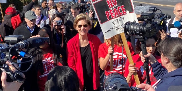 ​Democratic presidential candidate Sen. Elizabeth Warren of Massachusetts joins striking culinary union workers on the picket line in Las Vegas, Nev., in February 2020.