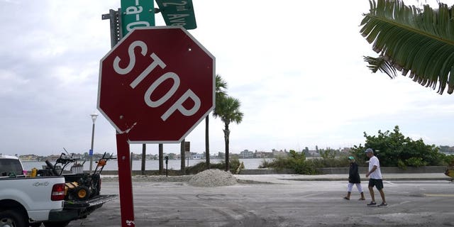 A street sign is damaged in the aftermath of Tropical Storm Eta, Thursday, Nov. 12, 2020, in the Passe-A-Grille neighborhood of St. Pete Beach, Fla. Eta dumped torrents of blustery rain on Florida's west coast as it slogged over the state before making landfall near Cedar Key, Fla. (AP Photo/Lynne Sladky)