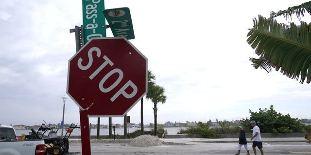A street sign is damaged in the aftermath of Tropical Storm Eta, Thursday, Nov. 12, 2020, in the Passe-A-Grille neighborhood of St. Pete Beach, Fla. Eta dumped torrents of blustery rain on Florida's west coast as it slogged over the state before making landfall near Cedar Key, Fla. (AP Photo/Lynne Sladky)