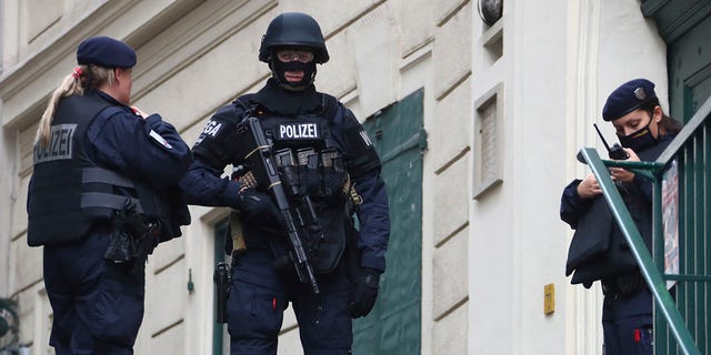 Police officers guard the scene in Vienna on Tuesday. (AP Photo/Matthias Schrader)