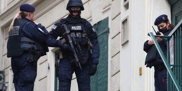 Police officers guard the scene in Vienna on Tuesday. (AP Photo/Matthias Schrader)