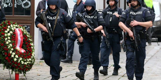 Armed police officers patrol on a street at the scene in Vienna, Austria, on Tuesday after a suspect shot and killed four people in a nightlife district, authorities said. Police in the Austrian capital said several shots were fired shortly after 8 p.m. local time on Monday. (Photo/Ronald Zak)