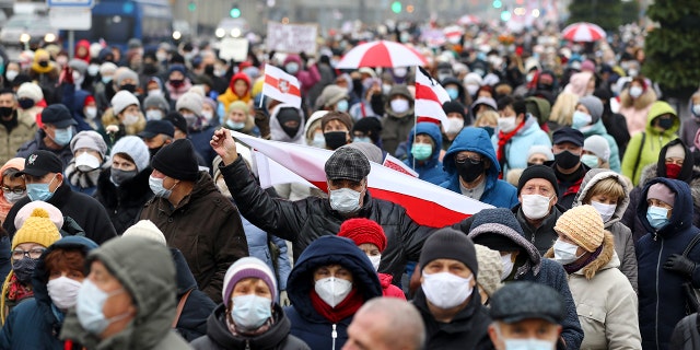 Belarusian pensioners wearing face masks to protect against coronavirus attend an opposition rally to protest the official presidential election results in Minsk, Belarus, Monday, Nov. 16, 2020. Crowds of retirees marched down the streets of the Belarusian capital on Monday, demanding the resignation of the country's authoritarian president and to end the government crackdown on peaceful protesters. (AP Photo)