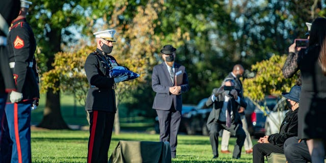 Georgie Carter-Krell, seated at right, is presented with American flag at her son Pfc. Bruce Carter's burial at Arlington National Cemetery