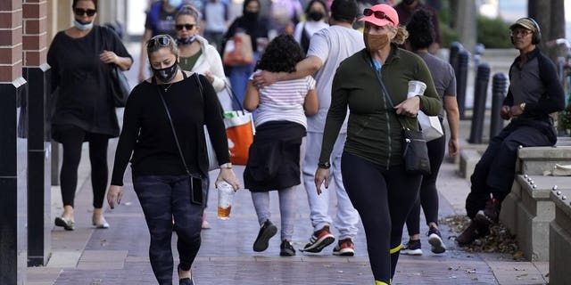<br>In this Nov. 6, file photo, people walk in downtown Evanston, Ill. With the coronavirus coming back with a vengeance across the country and the U.S. facing a long, dark winter, governors and other elected officials are showing little appetite for reimposing the kind of lockdowns and large-scale business closings seen last spring. (AP Photo/Nam Y. Huh, File)