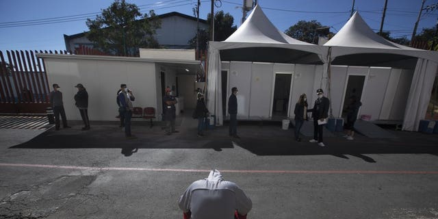 <br>
A young man waits to be tested for COVID-19 outside the Ajusco Medio General Hospital in Mexico City, Thursday, Nov. 19, 2020. (AP Photo/Marco Ugarte)