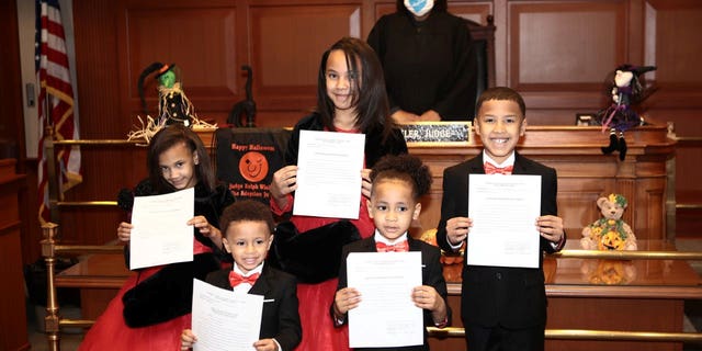 Robert Carter adopted Marionna,10 , Robert Jr., 9, Makayla, 8, Giovanni, 5, and Kiontae, 4, on Oct. 30. (SWNS)