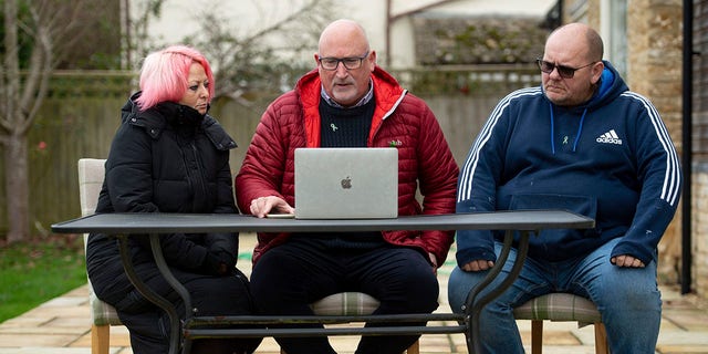 Family adviser Radd Seiger, center, sits with Charlotte Charles and Tim Dunn, parents of 19-year-old Harry Dunn, at their home in Charlton, England, on Tuesday. (Jacob King/PA via AP)