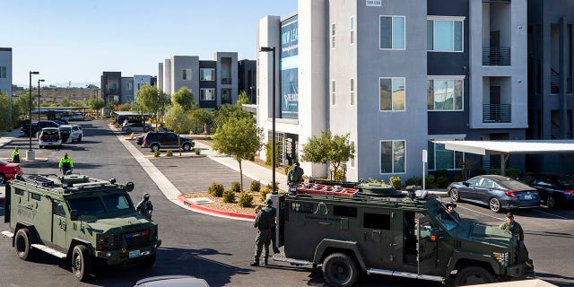 Henderson Police officers and SWAT vehicles are shown at the scene of a fatal shooting in an apartment complex in Henderson, Nevada. Four people were killed including the suspect in the shooting, police said. (Steve Marcus/Las Vegas Sun via AP)
